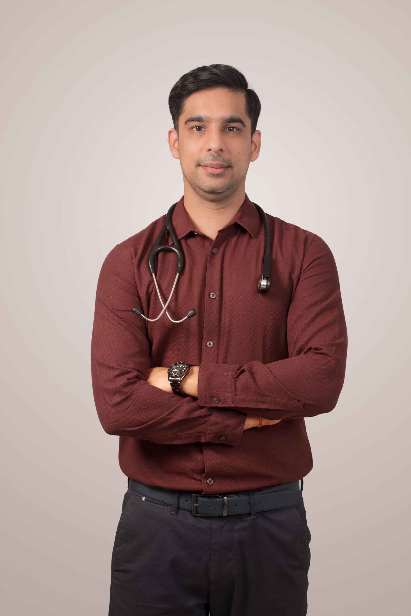 Dr Raghav Oza, professional psychiatrist, posing with a stethoscope for his official medical profile
